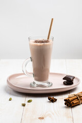 Lassi is a refreshing traditional Indian drink. Prepared for yoghurt with the addition of water, salt, sugar, spices, chocolate and ice by quick whipping. Close-up. Copy space.
