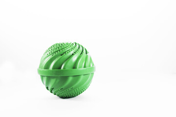 A green reusable wash ball on the left of a white background