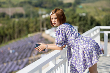 A smart woman short hair in soft dress  on cafe hight hill, she is happy and like on trip for...