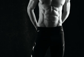 man with pumped up abs exercises motivation dark background
