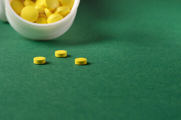 selective focus on three yellow pills. Dose of vitamins to maintain immunity