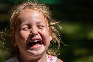 the child is crying and laughing, the child is hysterical - obrazy, fototapety, plakaty