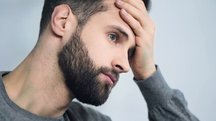 Fototapeta premium frustrated man touching forehead with hand