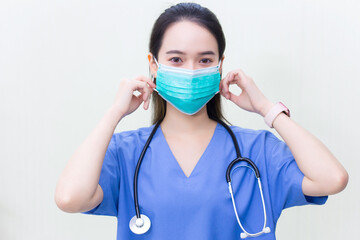 Asian professional woman doctor is wearing medical  face masks to protect from Coronavirus-19 (COVID-19) in healthcare and new normal concept.