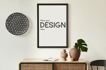 Minimalist composition of living room interior with black mock up poster map, wooden commode, black round decoration, leaf in vases and elegant personal accessories. Template.