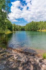 The forest lake, which appeared on the site of quarries, is surrounded by forest on all sides.