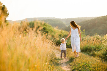 Mother and little boy on walk in nature