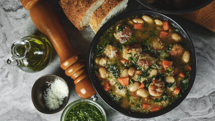 Farm homemade soup with meatballs cutlets and vegetables in big pot on home kitchen background. Copy space, closeup. Homemade food recipe concept.