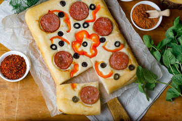 Cut Piece Of Creative Focaccia Pizza Inverted Pie Staffed Cheese And Food Art On The Top. Flat Lay.