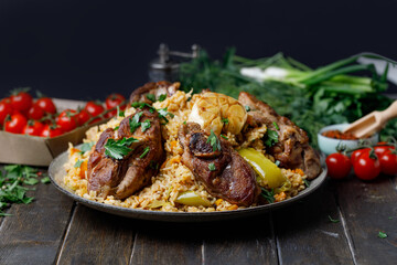 Traditional Pilaf With Lamb, Vegetables, Spices On Wooden Table Black Background. Side View.
