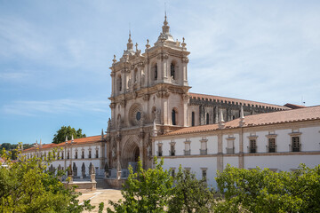 View at the facade of the Alcobaça Monastery (Mosteiro de Santa Maria de Alcobaça), a Catholic monastic complex, the church are Gothic, the towers are Baroque