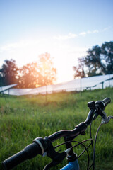 Fototapeta na wymiar Bicycle in the solar farm for green energy.