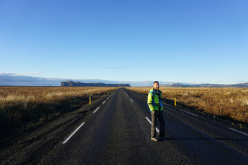 Fototapeta na wymiar Young man standing on Route 1, Iceland