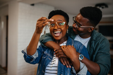 Black woman relaxing at home and using digital tablet