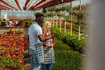 Diverse coworkers working together in greenhouse