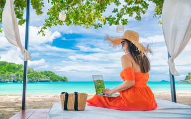 Traveler Asian woman relaxing at sea beach using laptop, Businesswoman on vacation at private...