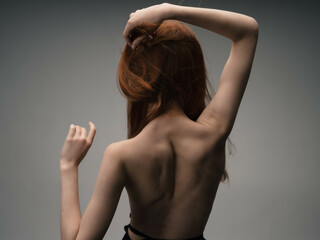 redhead woman nude back posing clean skin studio