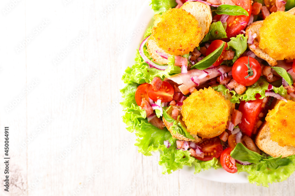 Sticker goat cheese salad with tomato and bacon