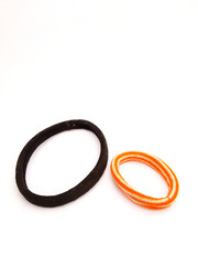 black and yellow rubber bands on white background, rubber band top view