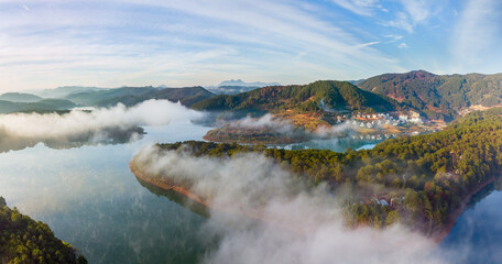 Panoramic view in early morning of an alpine village and lake near city of Dalat in Vietnam.