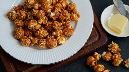 Caramel popcorn on the white ceramic plate