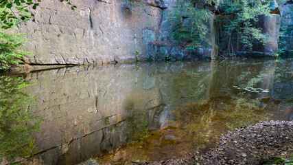 abstract reflection of rocks in calm water in a remote place nature background