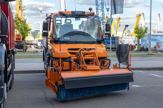 Construction Industry Fair Bauma CCT Russia. Orange utility truck Mercedes-Benz Unimog U423 with rotatry brush for cleaning roads. Moscow, Russia - May 25-28, 2021