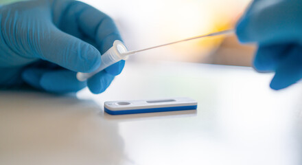 Man using a rapid antigen test kit. Rapid antigen testing is a screening tool to help to detect...
