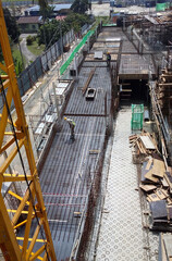 Fototapeta na wymiar PENANG, MALAYSIA -JUNE 18, 2021: Structural works are underway at the construction site. Construction workers are installing formwork made of metal or timber. Safety features are paramount. 