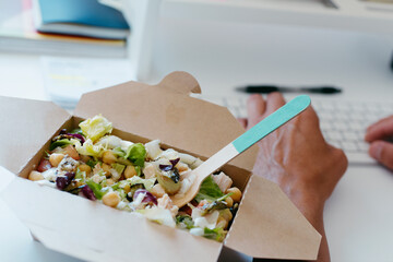 chickpea salad and man sitting at his desk