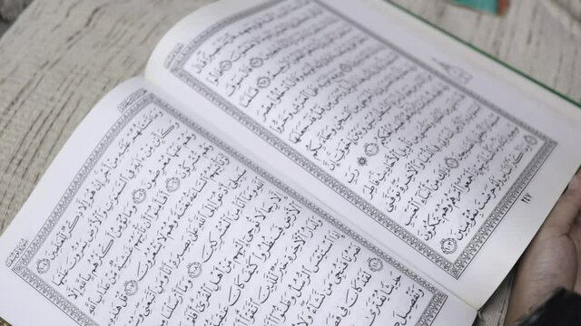 closeup clip of muslim people reading al-quran 