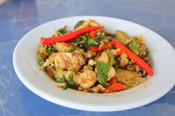 Fried Spicy Frog with herb and spices on plate - Stir fried frog and red curry paste