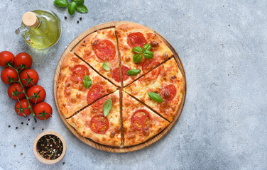 Classic pizza margarita with tomato sauce and cheese on a wooden board, top view.