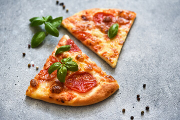 Slice pizza with sauce, cheese and basil. Cassic pizza margarita.