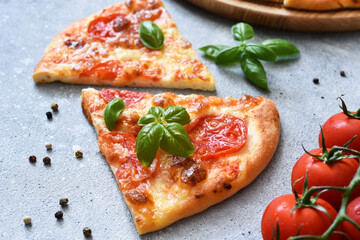 Slice pizza with sauce, cheese and basil. Cassic pizza margarita.