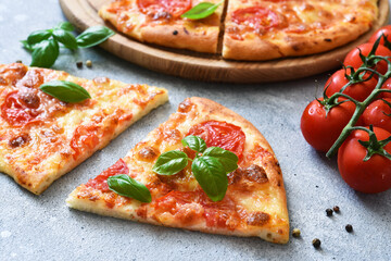 Slice pizza with sauce, cheese and basil. Cassic pizza margarita.