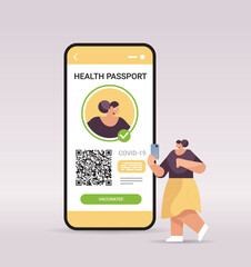 woman traveler using digital immunity passport with qr code on smartphone screen risk free covid-19 pandemic