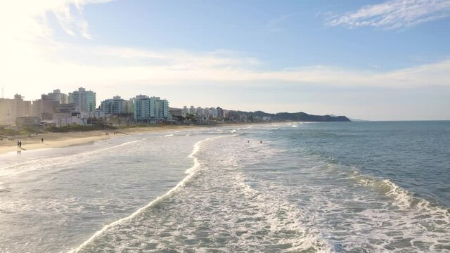 Aerial view of waves at brava beach during scenic sunset, Itaja&iacute;, Brazil.