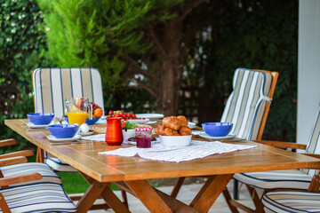 Laid table with food.Breakfast on the terrace.A table with food for a large family.A party.Banquet.Dinner on the summer terrace.Birthday on the street.Dining table with food.Lots of food on the table