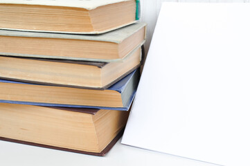 old thick textbook on the school desk , knowledge concept  study hard