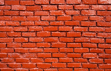 Brick painted red wall. Bright background                  