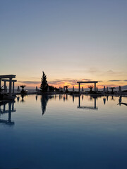 Obraz premium Beautiful sunset over the empty pool and the sea. The Aegean sea. Turkey, Kusadasi.