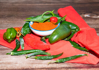 Fresh  red and  green chilli peppers  with ground  chilli powder 