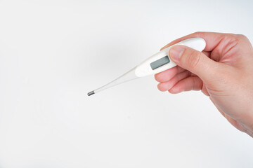 Woman hand holding thermometer on white background. isolated.thermometer shows high temperature.