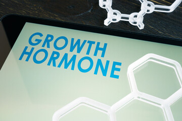 Growth hormone on the tablet screen with chemical symbols.