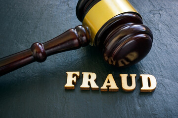 Word fraud and gavel as symbol of justice.