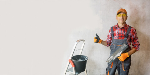 Mature plasterer showing thumbs-up near wall. Hight quality of construction work concept.