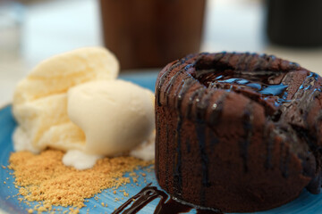 Summer cafe concept: vanilla ice cream with hot chocolate souffle or lava cake served on blue cake,...