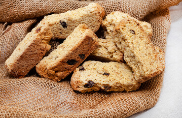 South African muesli health rusk with raisins on rustic table with burlap