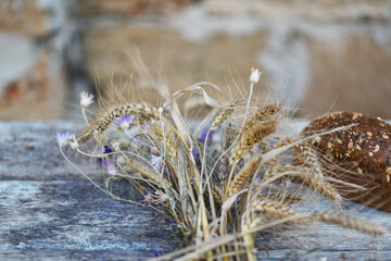 still life with bread and stalks of cereal plants